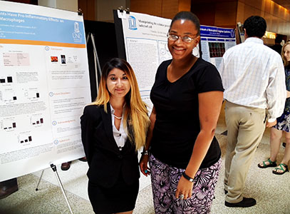 Two women posing at research event