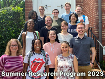 Group of students posing on a building's steps. Text reads "Summer Research Program 2023".